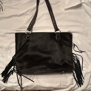 Black leather purse with fringe.